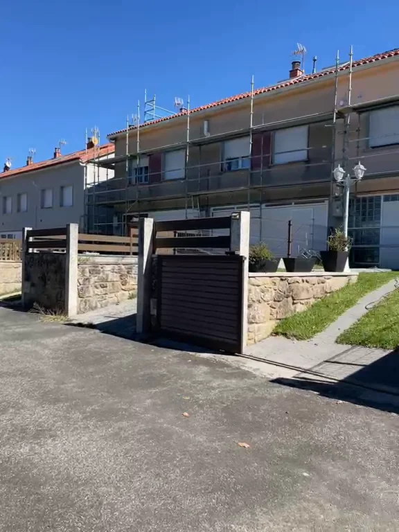 Viviendas adosadas con andamio montado para la rehabilitación de fachada